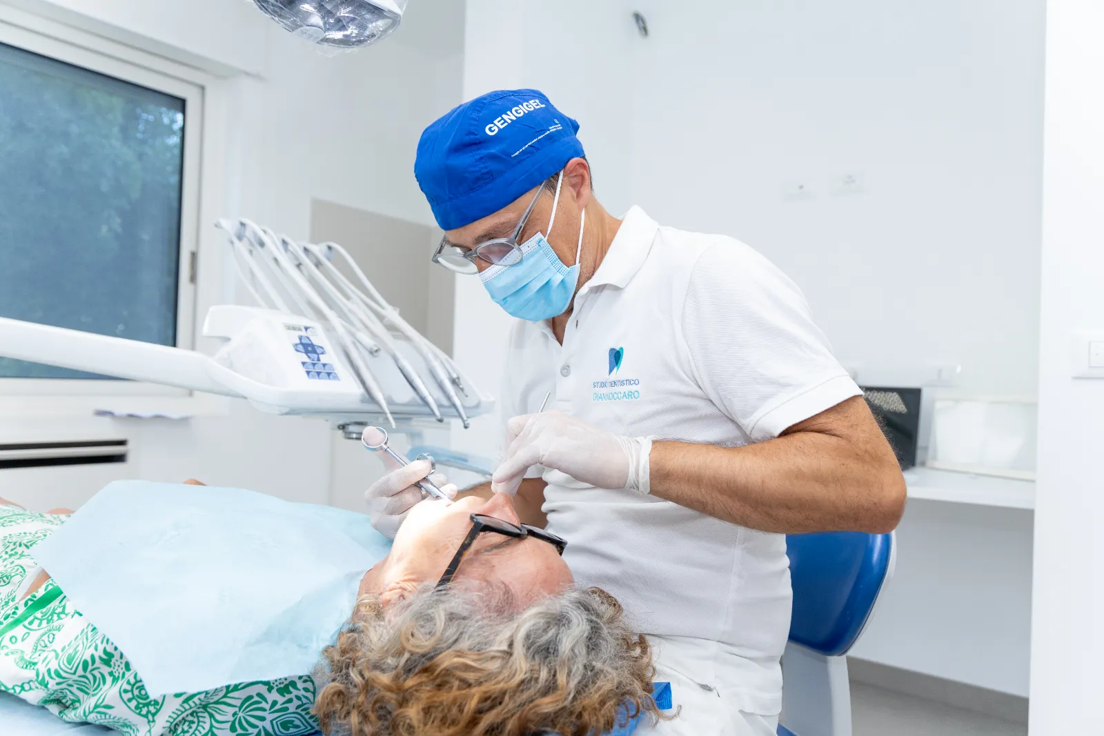 Il dentista visita una paziente per valutare la carie prima di intervenire